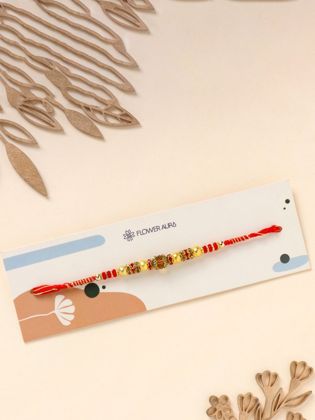 

Floweraura Golden Beaded Rakhi Bracelet With Roli Chawal, Red