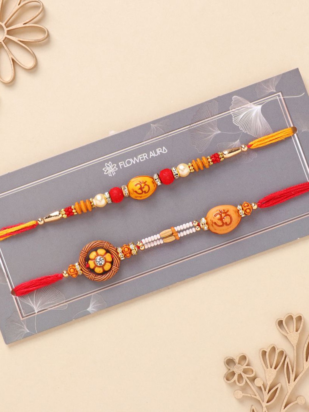 

Floweraura Set Of 2 Stone Studded & Beaded Thread Rakhi With Roli Chawal, Gold