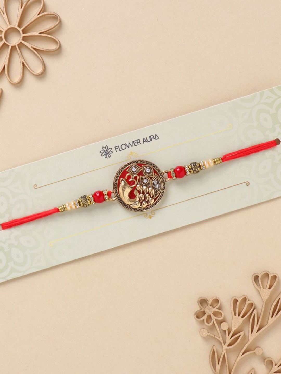 

Floweraura Stone Studded & Beaded Thread Rakhi With Roli Chawal, Gold