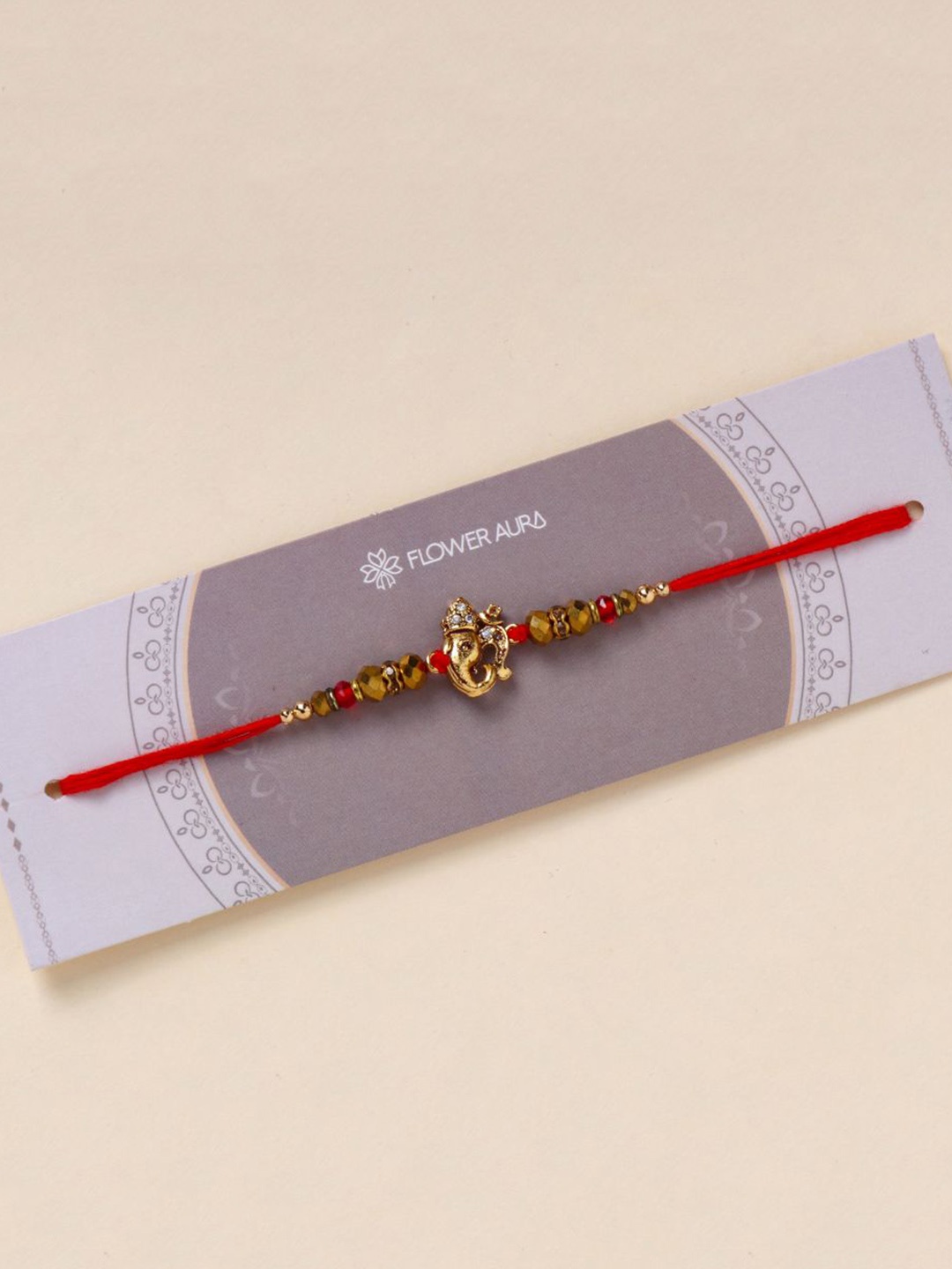 

Floweraura Lord Ganesha Beaded Thread Bracelet Rakhi with Roli Chawal, Red