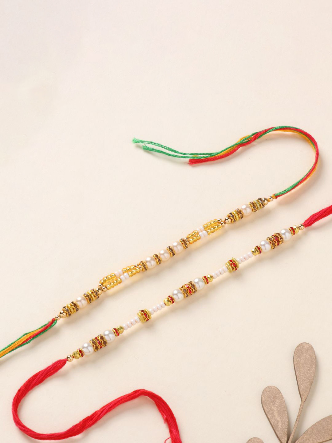 

Floweraura Set Of 2 Pearl Beaded Thread Rakhi With Roli Chawal, Red