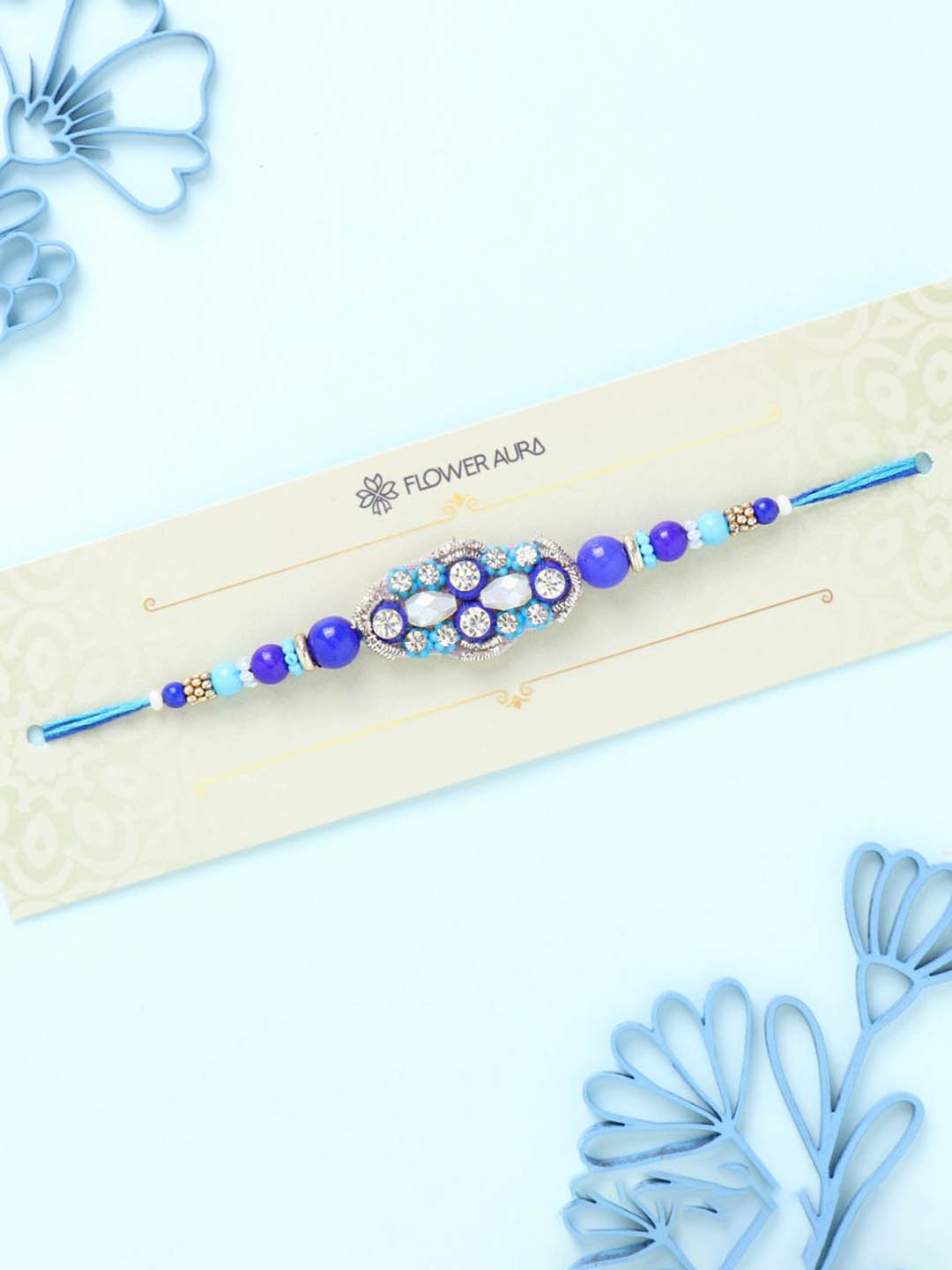 

Floweraura Stone Studded & Beaded Thread Rakhi With Roli Chawal, Blue