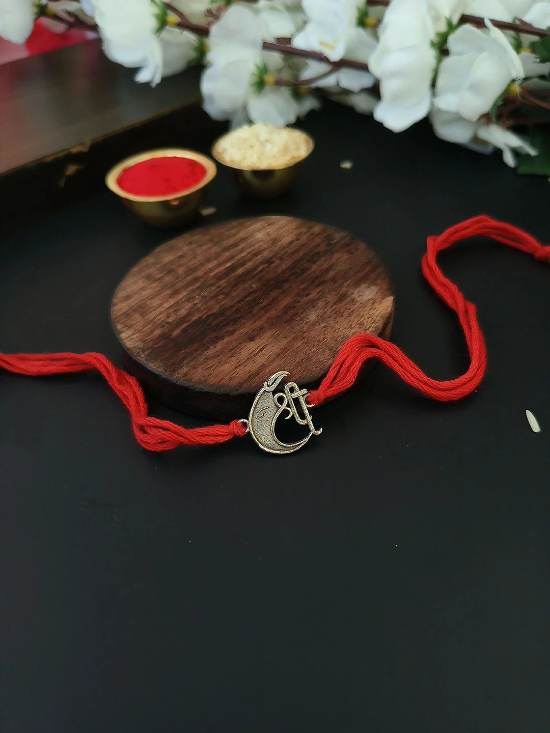 

Sangria Red Shree Ganesha Thread Rakhi