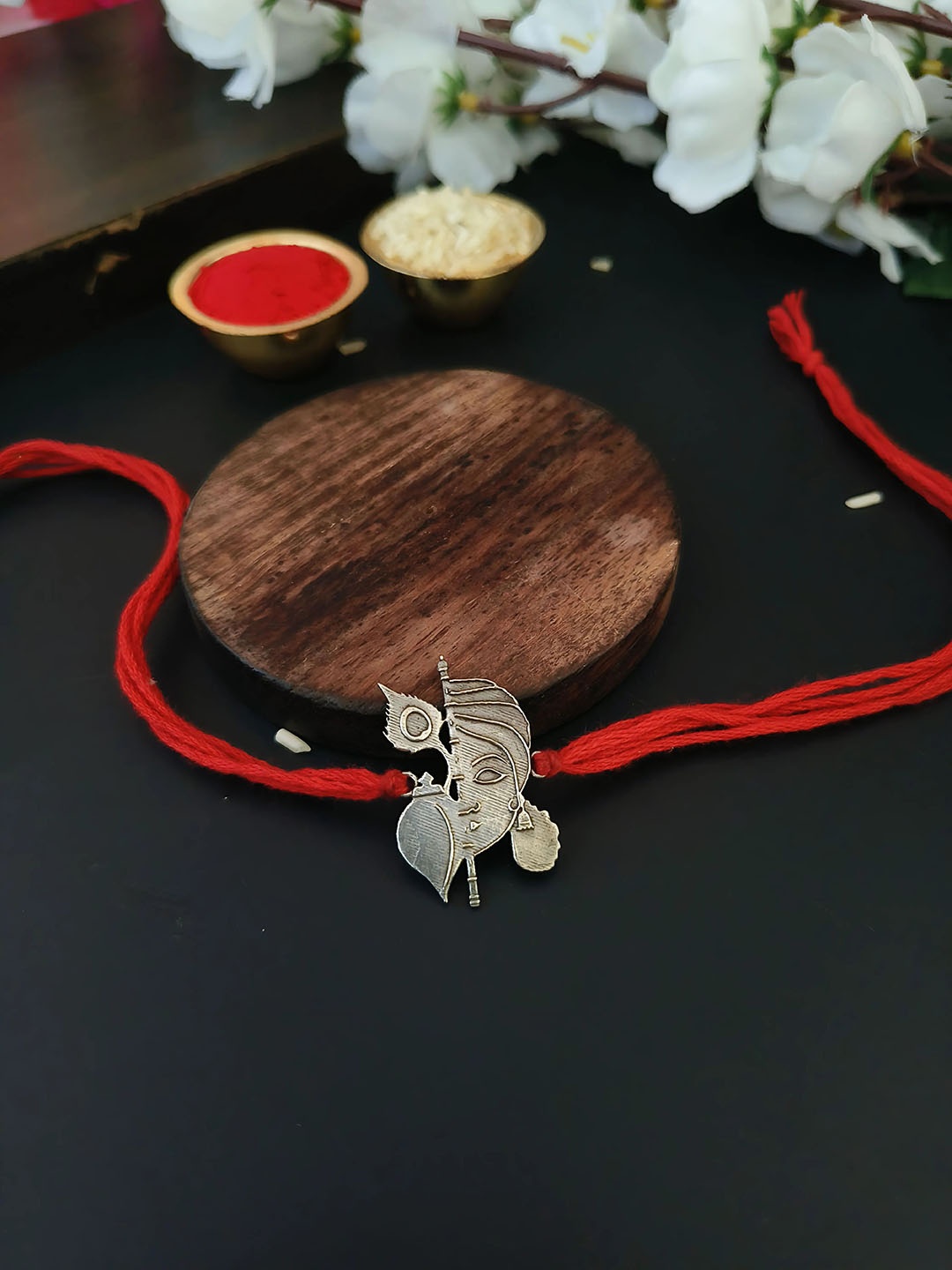 

Sangria Red Silver Plated Krishna Thread Rakhi