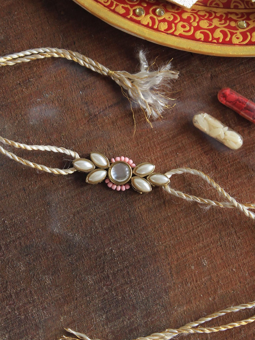 

BeAbhika Elegance Redefined kundan Studded Thread Rakhi With Roli Chawal Vegan Capsules, Pink