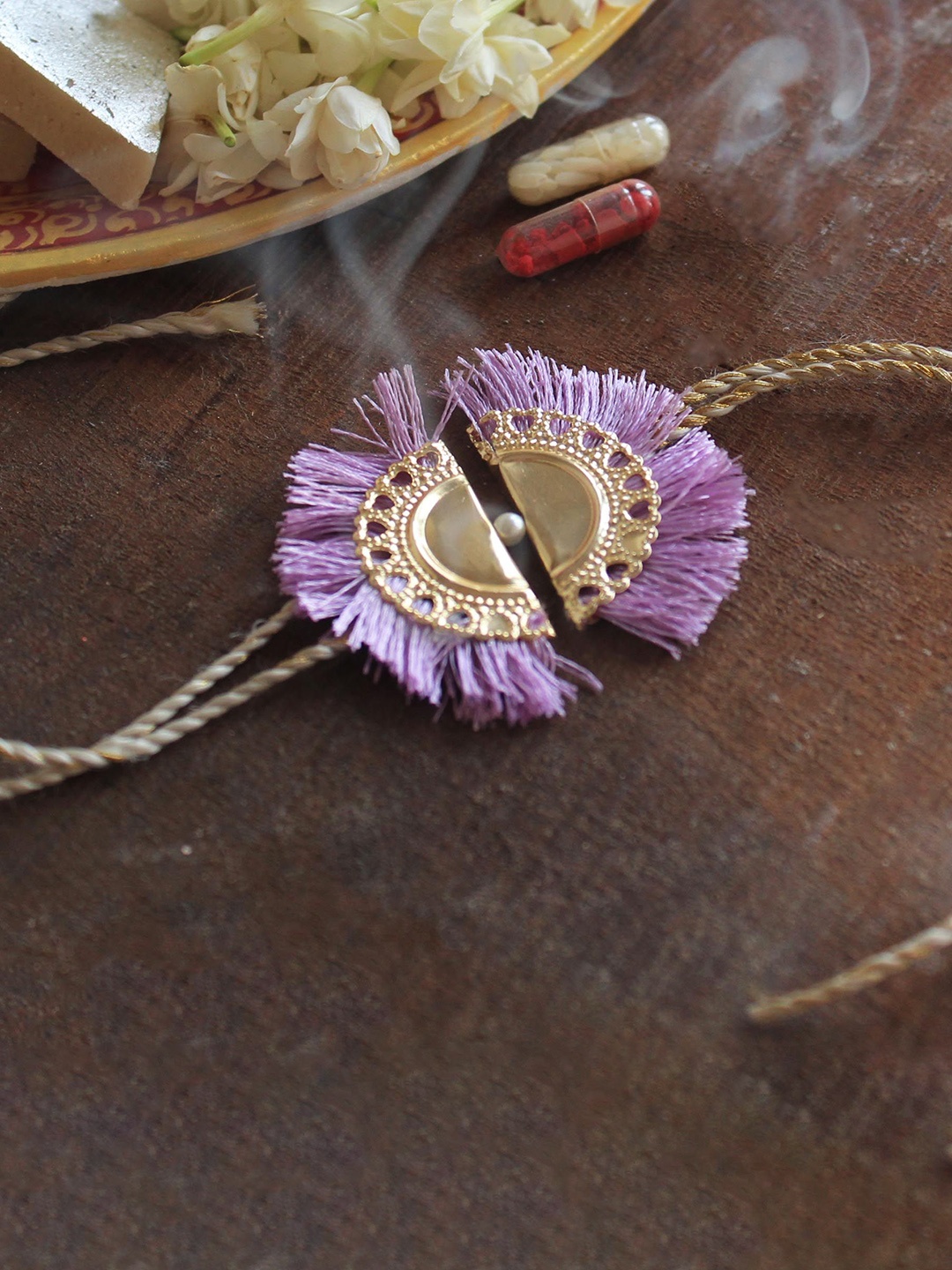 

BeAbhika Lilac Tassel Thread Rakhi With Roli Chawal Capsules, Gold