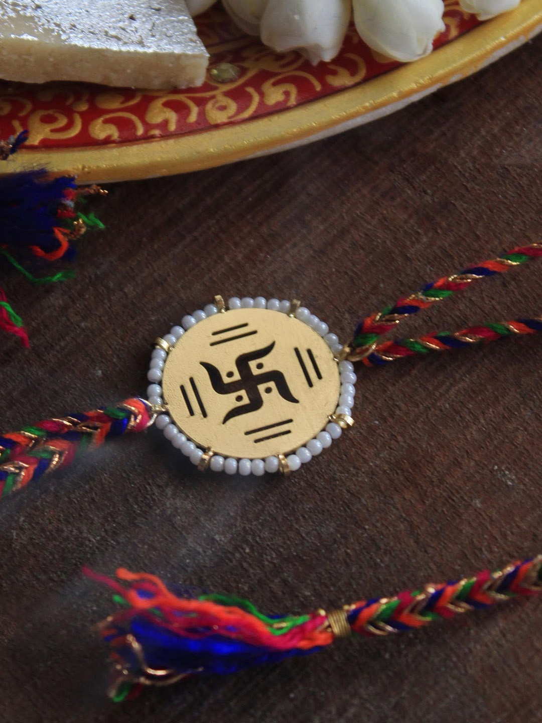 

BeAbhika Beaded Swastik Thread Rakhi with Roli Chawal Capsules, Gold