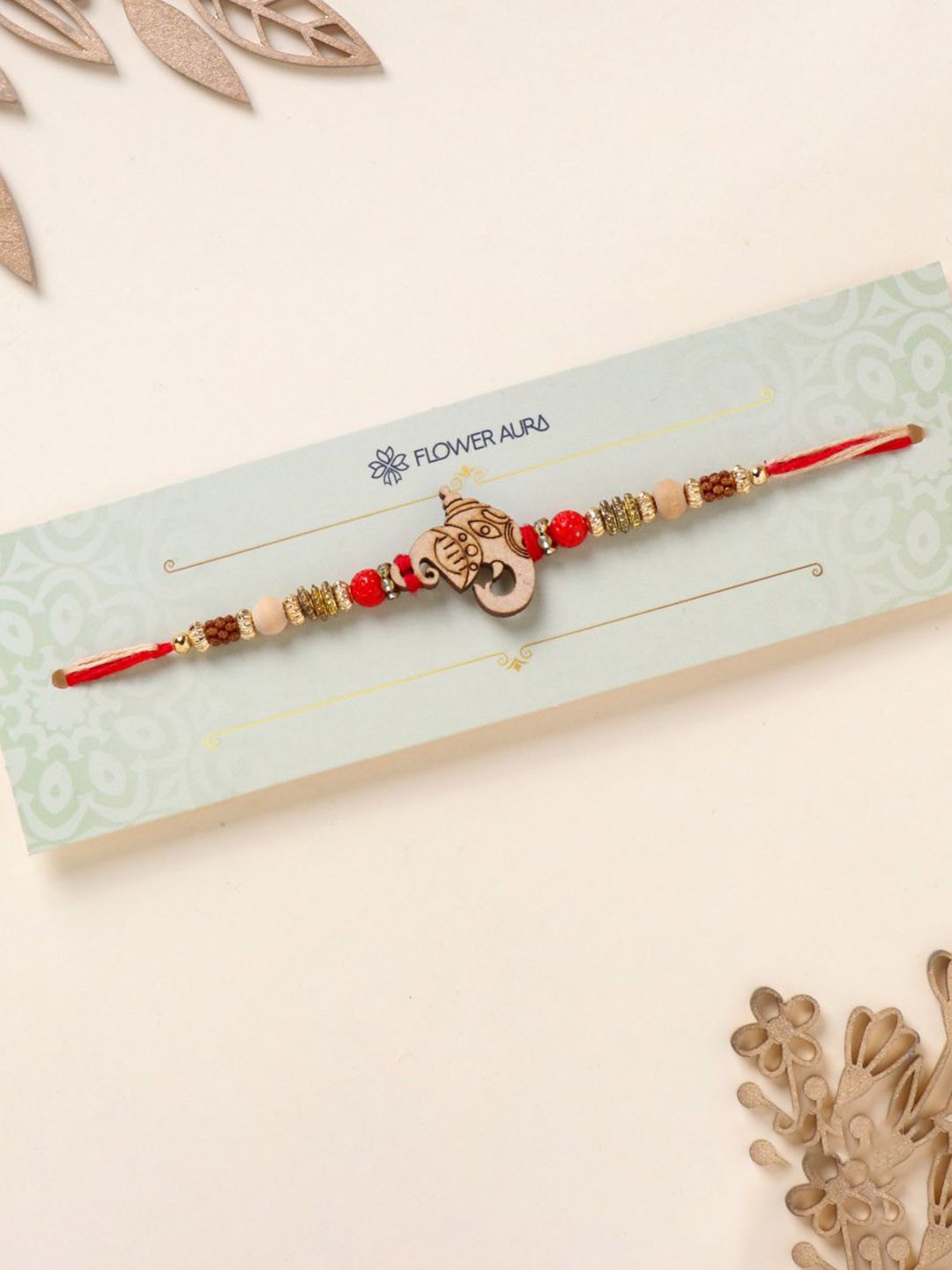 

Floweraura Wooden Lord Ganesha Beaded Thread Bracelet Rakhi with Roli Chawal, Gold