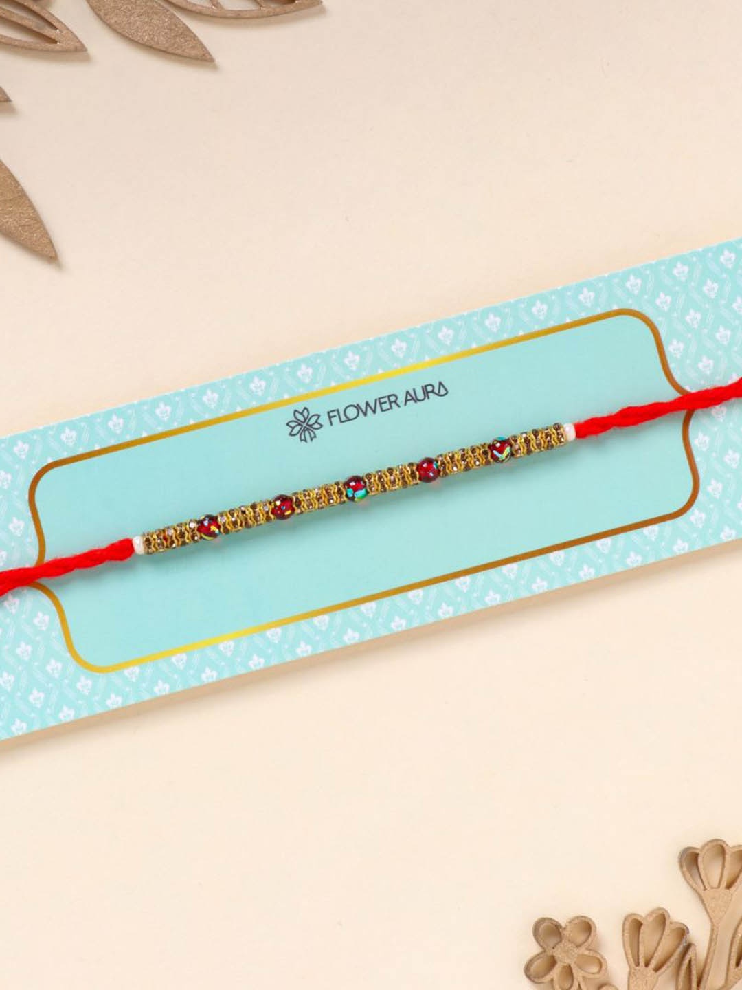 

Floweraura Stone Studded & Beaded Thread Rakhi With Roli Chawal, Red