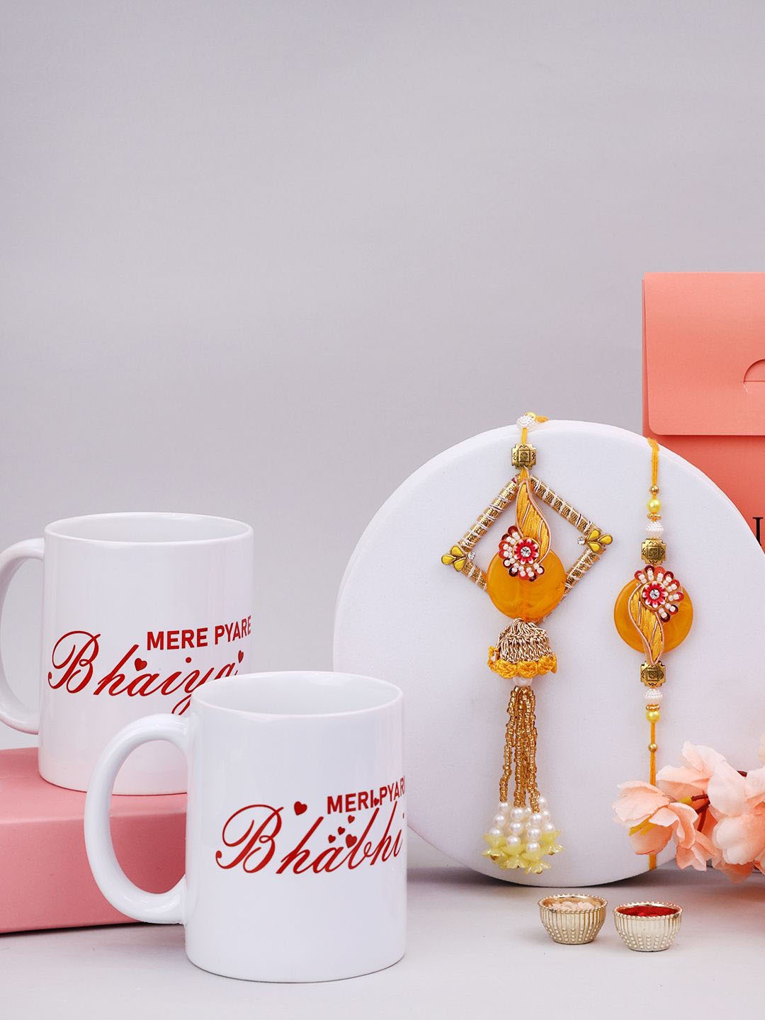 

PANASH Set Of 2 Stone-Studded & Beaded Rakhi With Roli Rice & Mugs, Gold