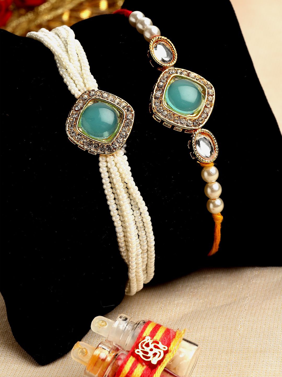 

PANASH Set Of 2 Gold-Plated Stone-Studded & Beaded Rakhis With Roli Chawal