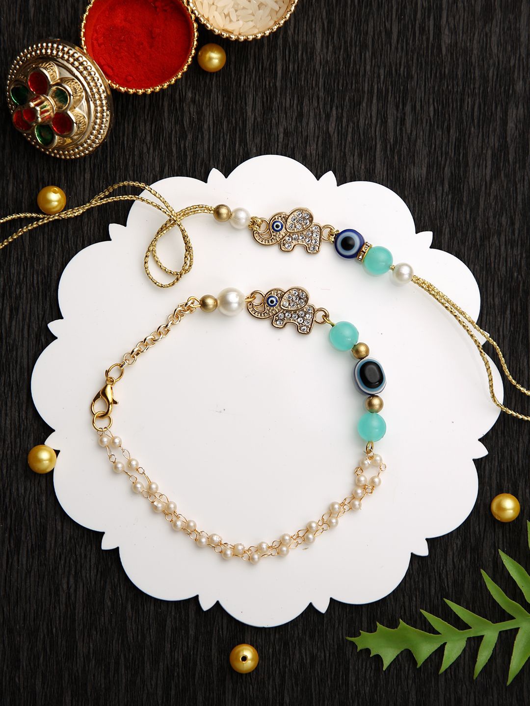 

Sangria Gold-Toned Elephant Charm Evil Eye Bhaiya Bhabhi Rakhi With Roli Chawal & Card