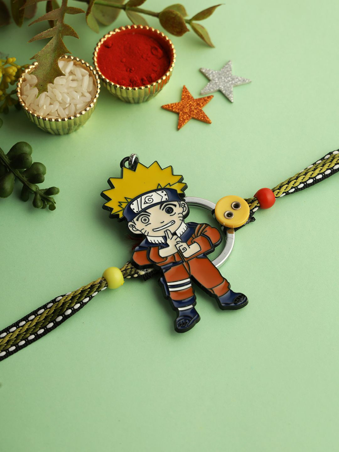 

Kook N Keech Brown Naruto Cartoon Thread Rakhi With Roli Chawal & Greetings Card