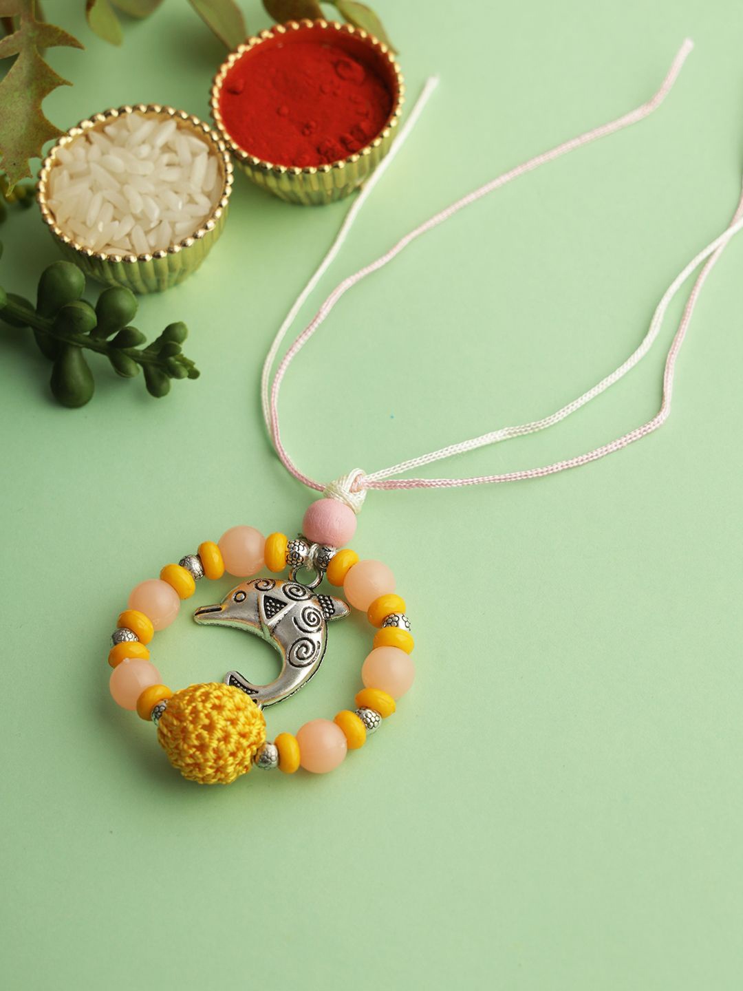 

Kook N Keech Yellow Whale Beaded Elasticated Rakhi with Roli Chawal & Greeting Card
