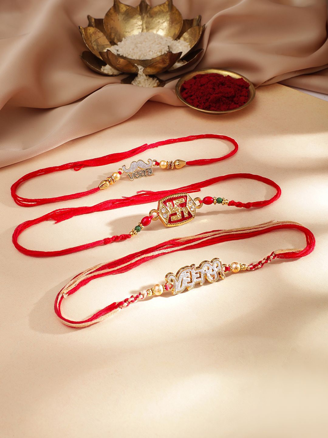 

Rubans Set Of 3 Veera And Swastik Motif Stone Studded Thread Rakhi, Orange