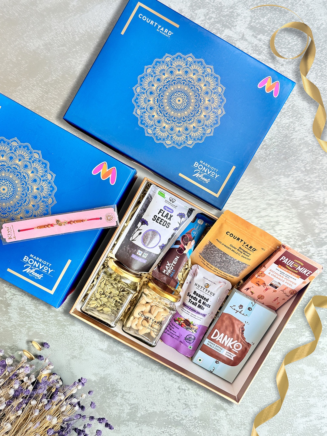 

Courtyard by Marriott - BLR ORR 9 Pcs Rakhi With Wellness & Health Assorted Gift Hamper, Blue