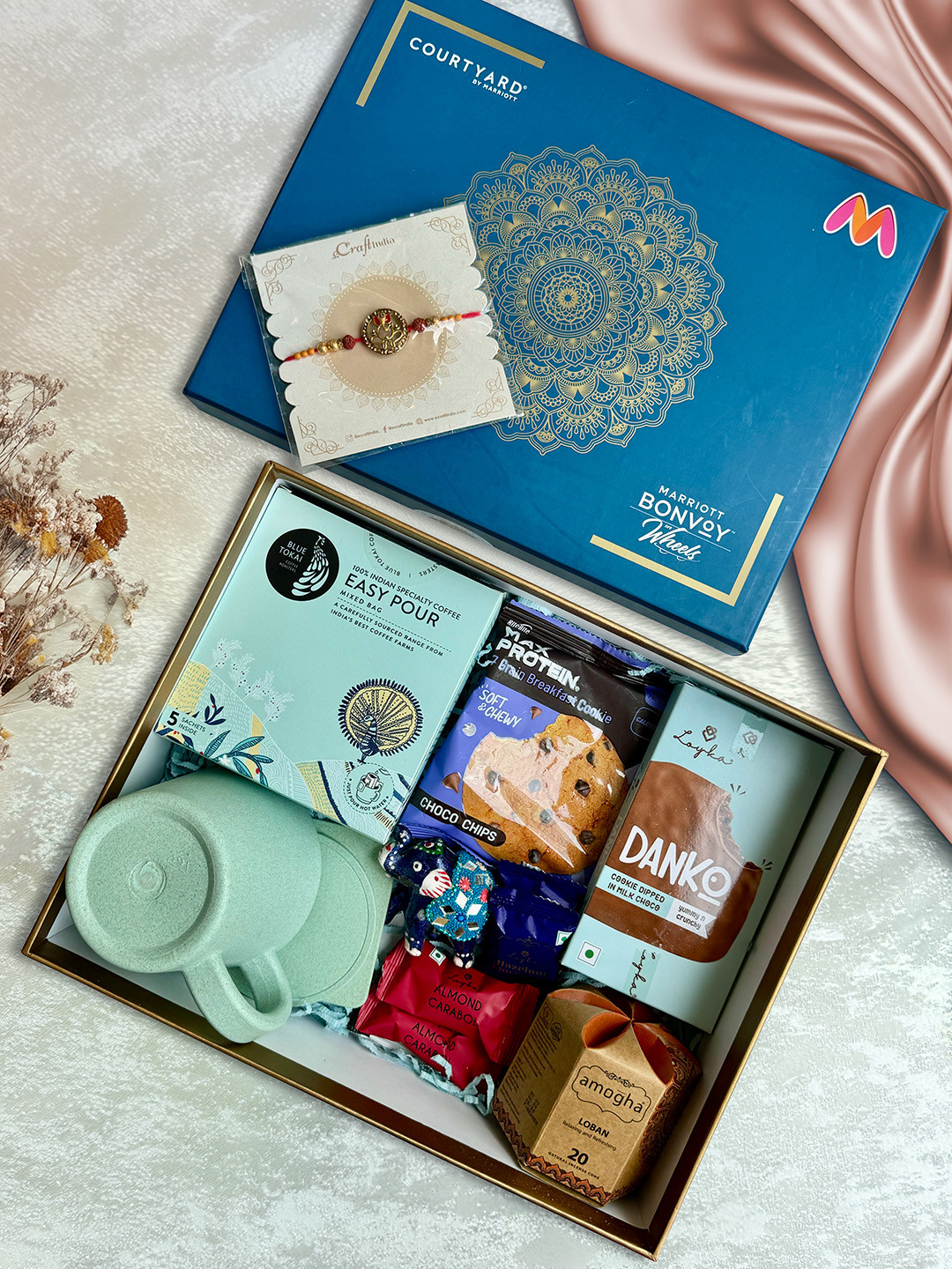 

Courtyard by Marriott - BLR ORR 13Pcs Rakhi With Assorted Gift Hamper, Blue