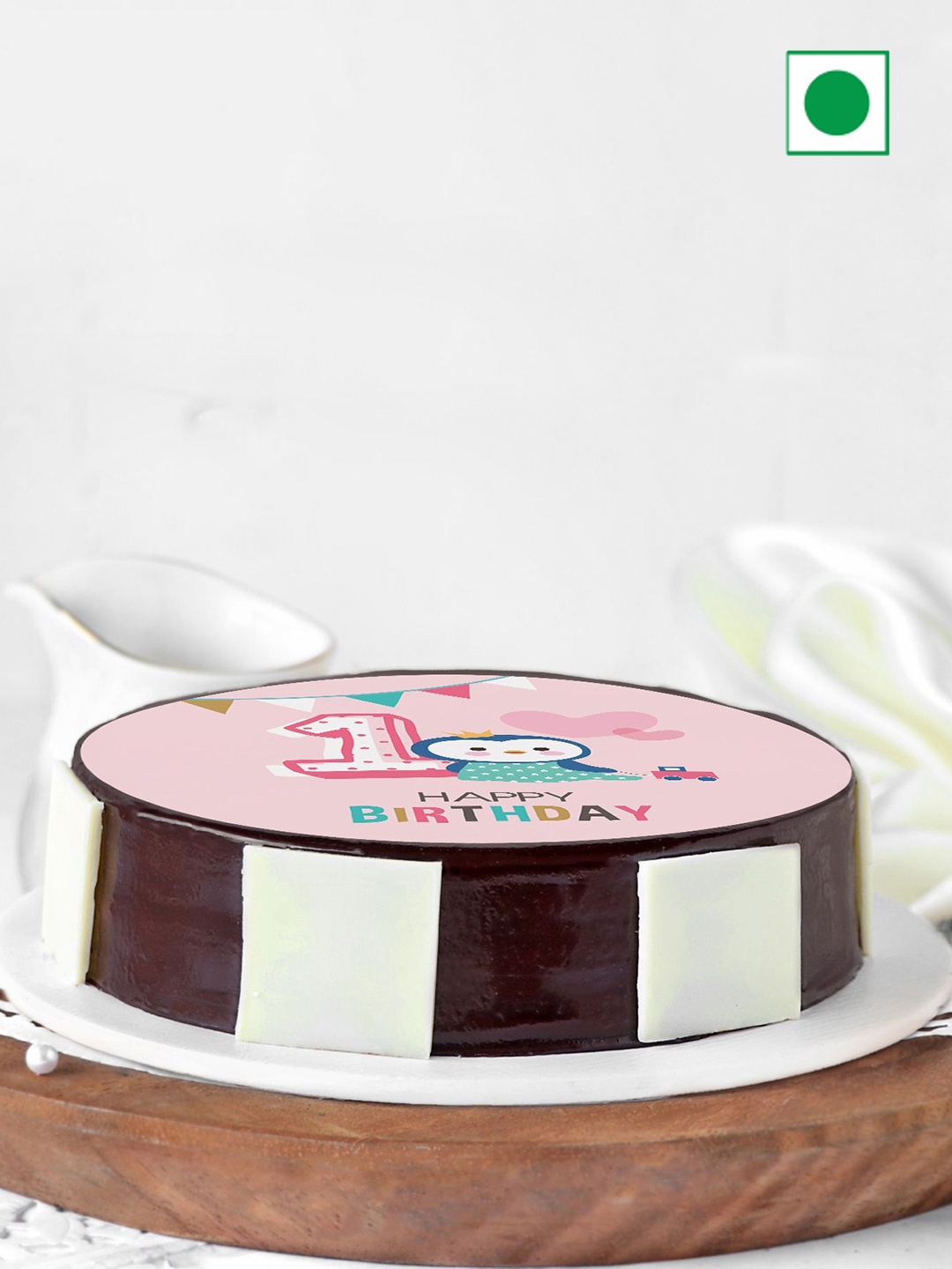 

IGP First Birthday Chocolate Flavour Eggless Round Cake- 1Kg, Coffee brown