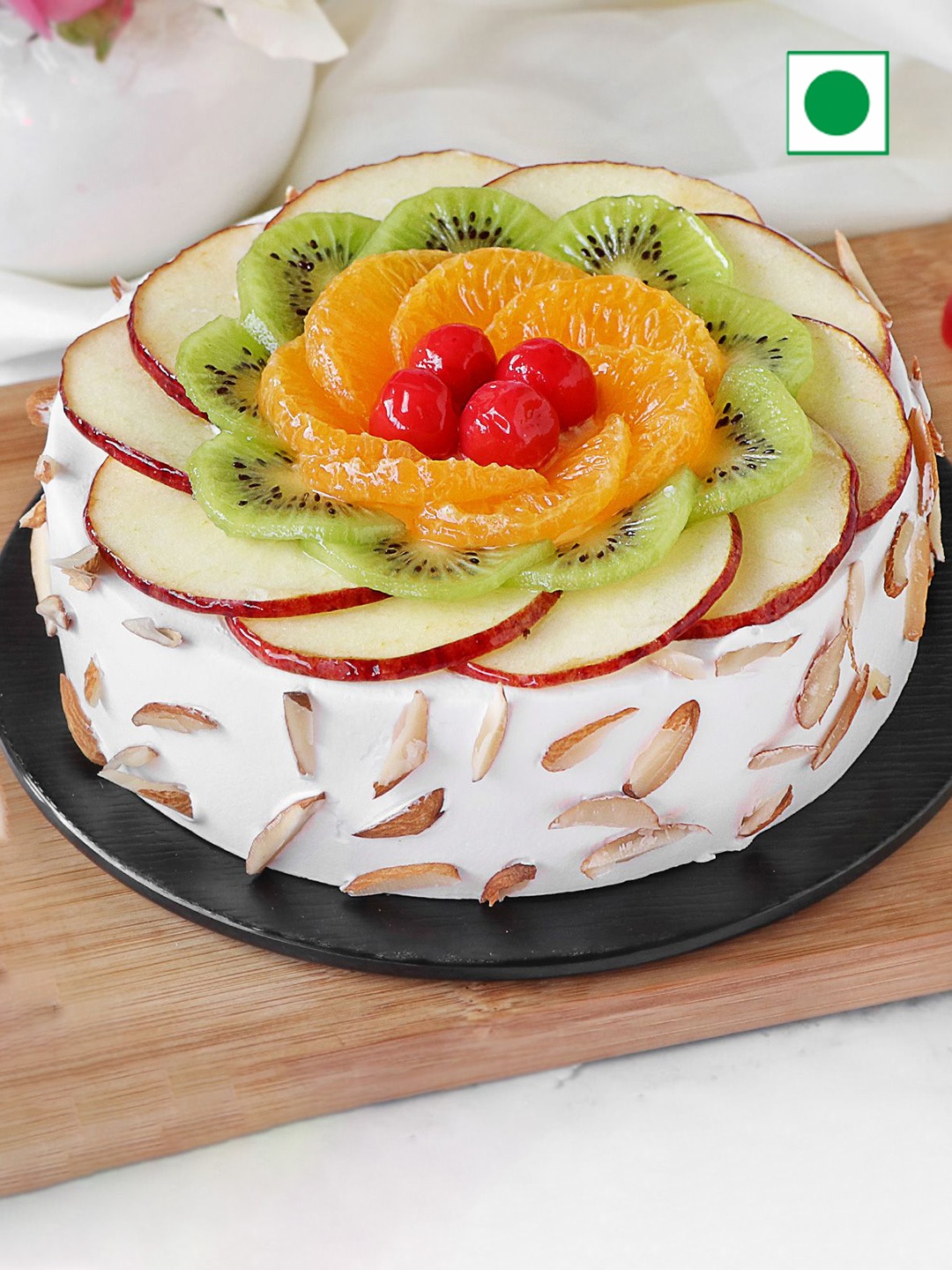 

IGP Fruit Almond Flavour Eggless Round Cake - 1 Kg, White