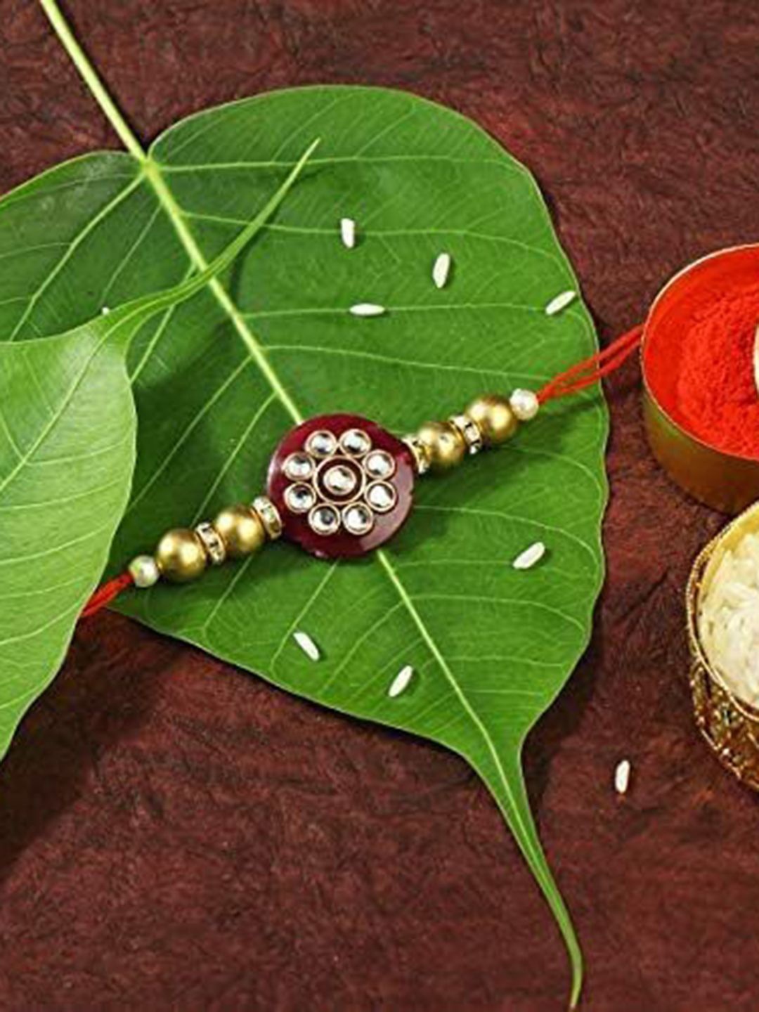 

Peora Kundan Studded Pearl Thread Rakhi with Roli Chawal and Greeting Card, Red