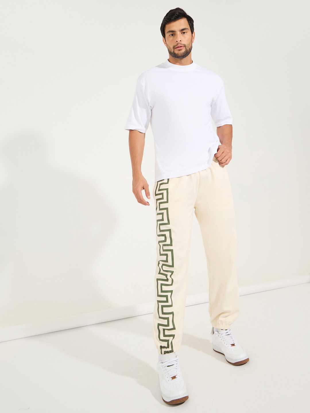 

Styli Men Relaxed Fit Joggers with Enlarged Print, Cream