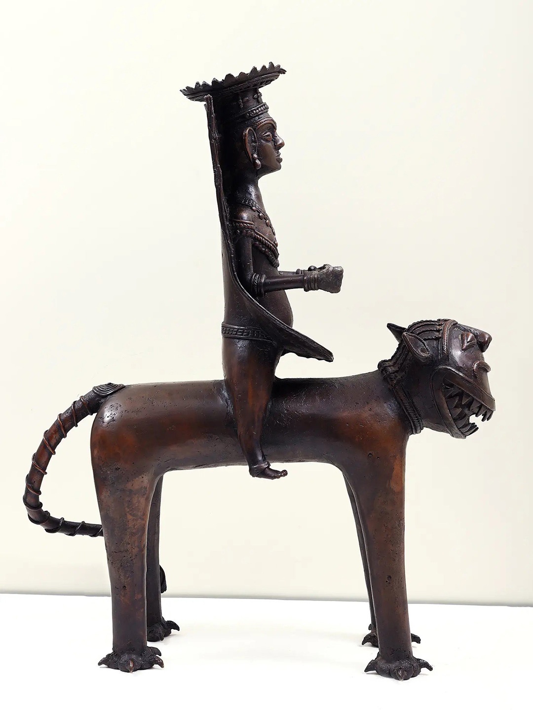 

Exotic India Brown Large Dhokra Art Tribal Man Sitting on Lion Brass Figurine Showpiece