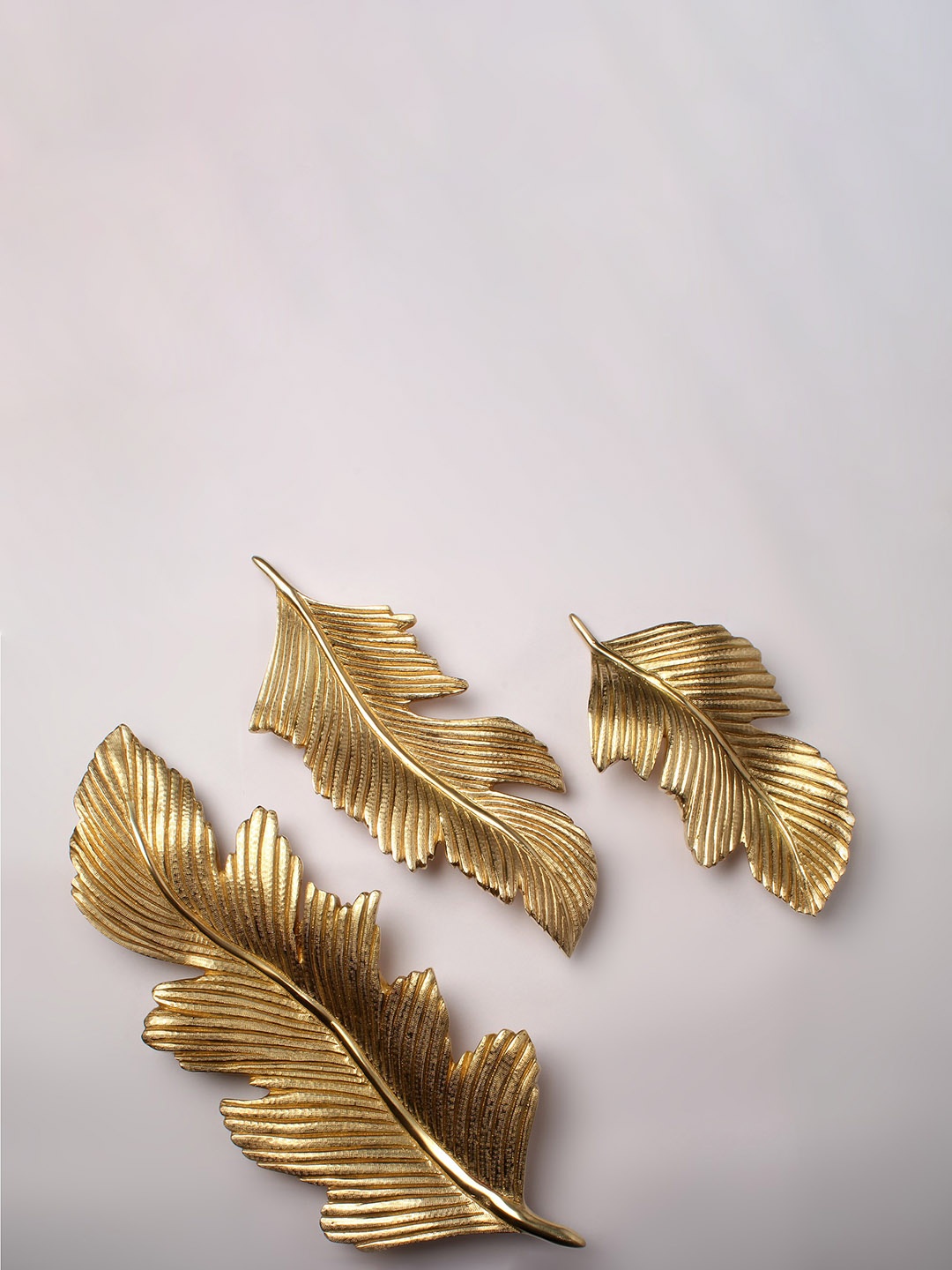 

Exotic India Gold-Toned 3 Pieces Textured Showpieces