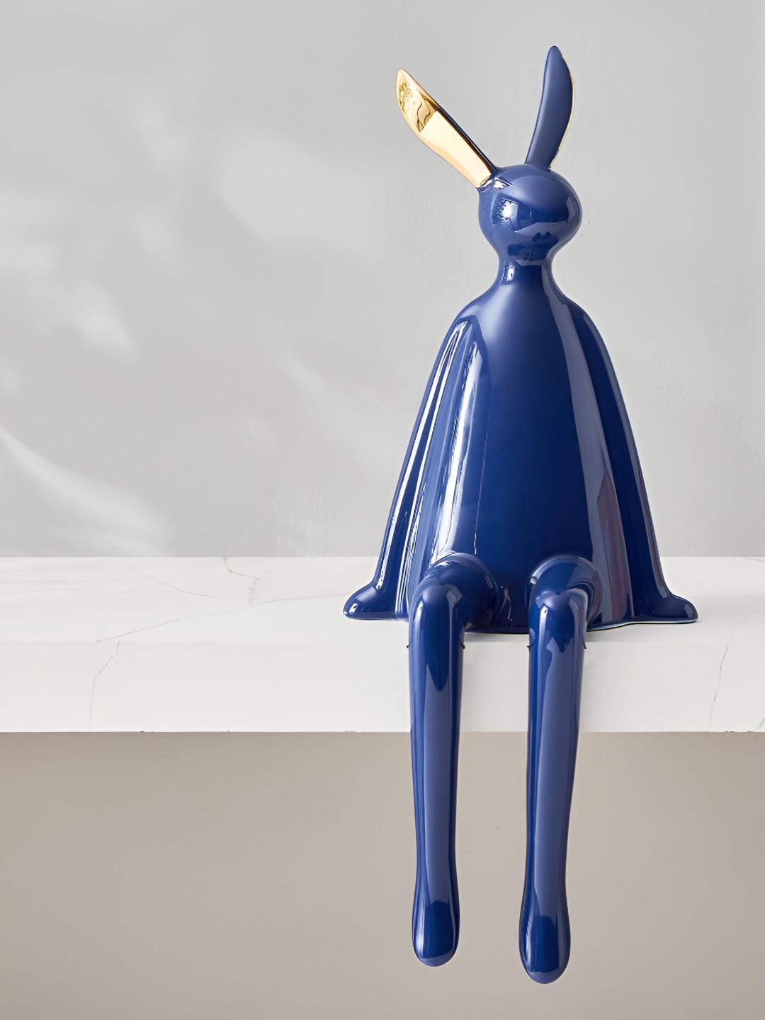 

Home Centre Thames Aero Blue & Gold Toned Sitting Figurine Showpiece
