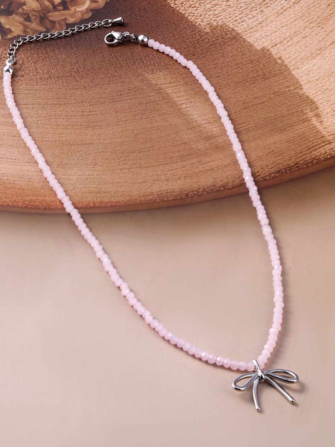 

Rubans Rhodium Plated Soft Pink Beaded Necklace with Silver Bow Pendant