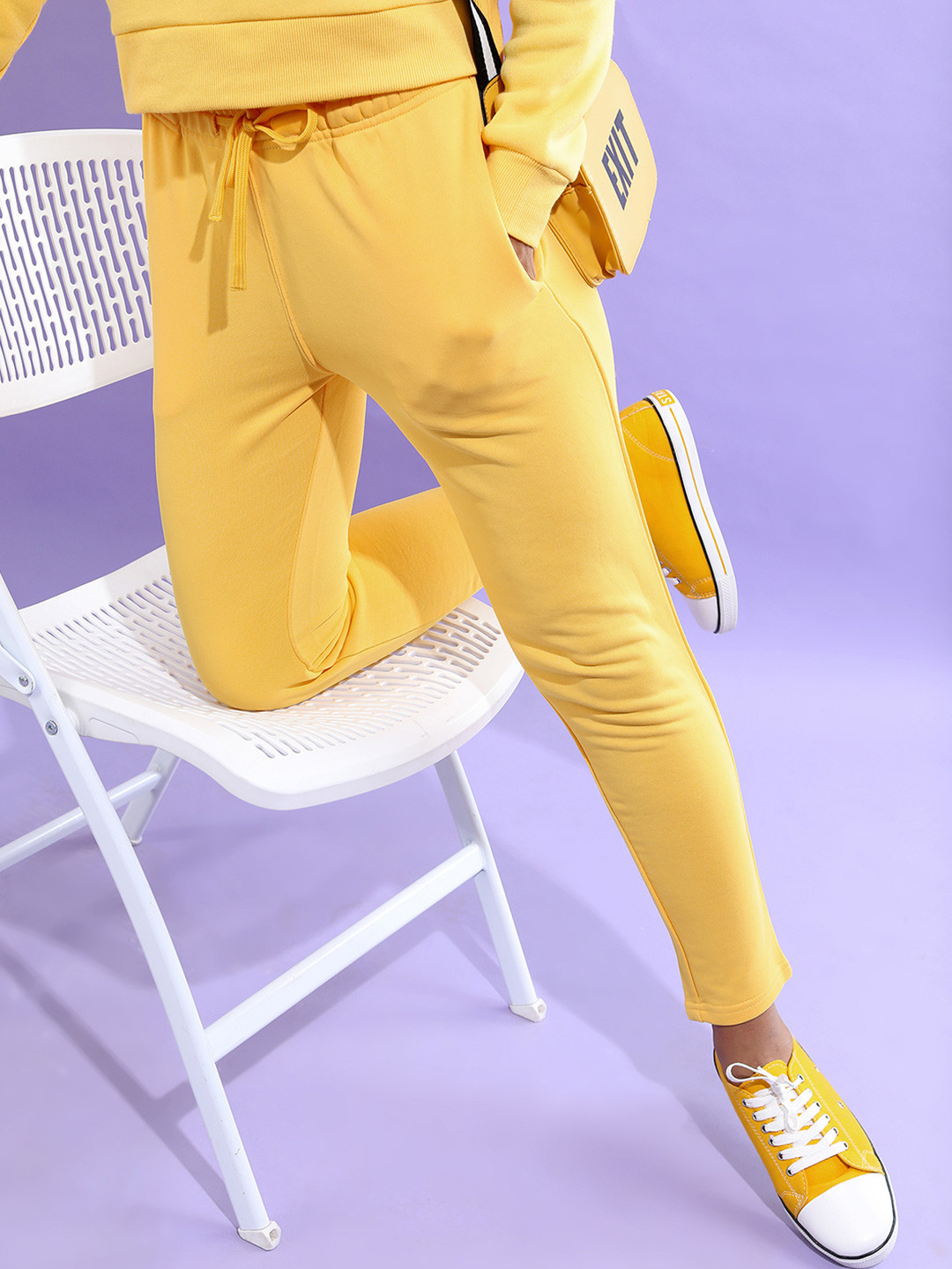 

Tokyo Talkies Women Solid Slim-Fit Mid-Rise Track Pants, Yellow