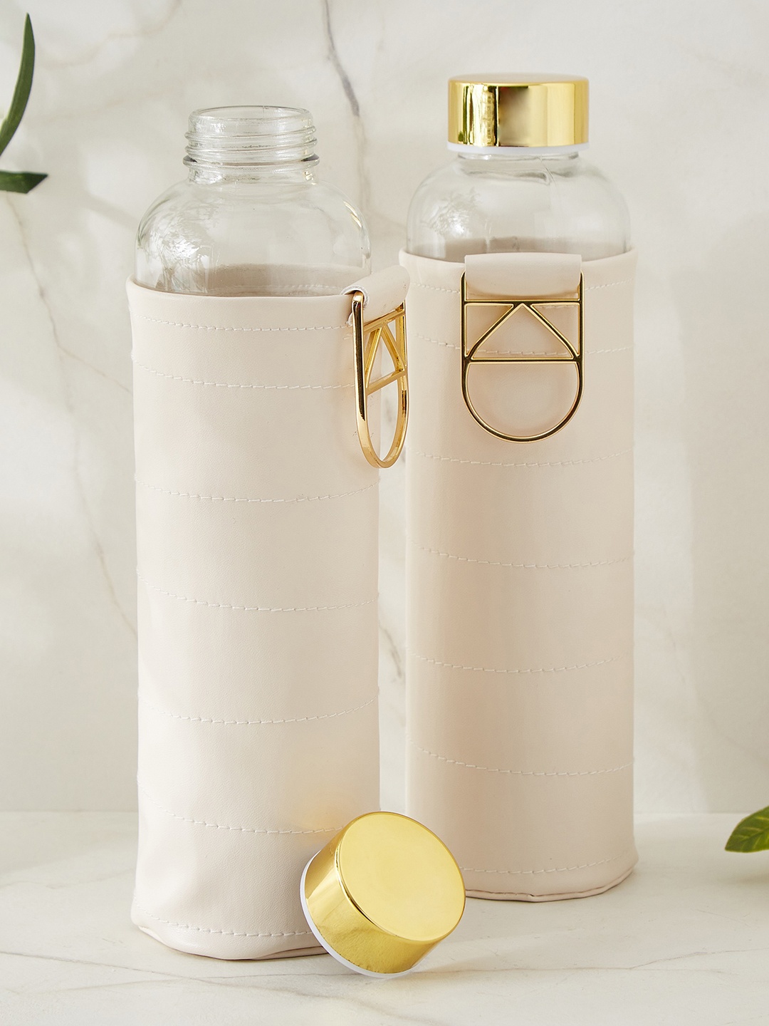 

Home Centre Transparent & Gold Toned 2 Pieces Glass Solid Water Bottle 600ml