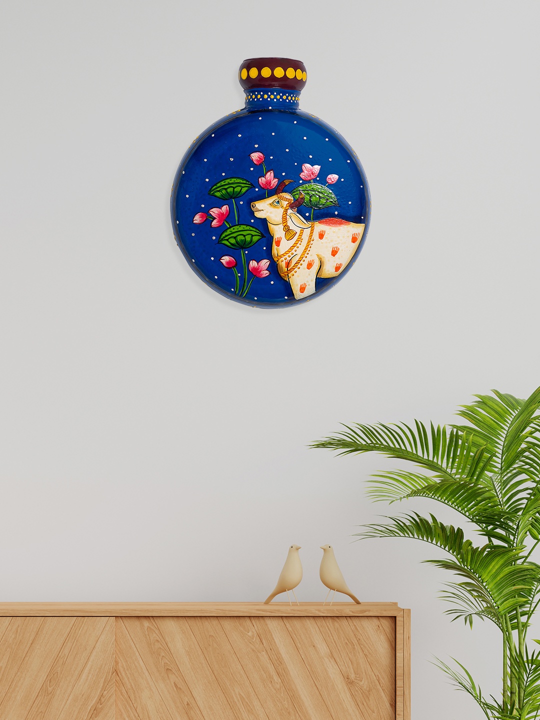 

Golden Peacock Blue & White Cow Printed Matka Shaped Hanging Wall Decor