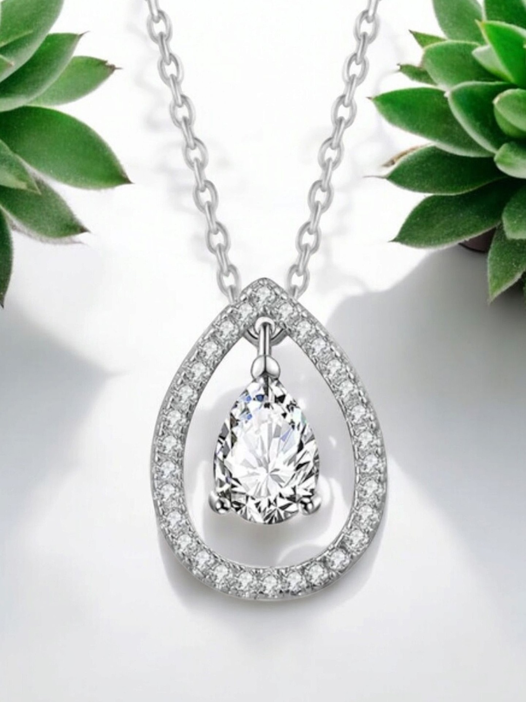 

Nilu's Collection Silver-Plated Cubic Zirconia Studded Teardrop Shaped Pendant with Chain