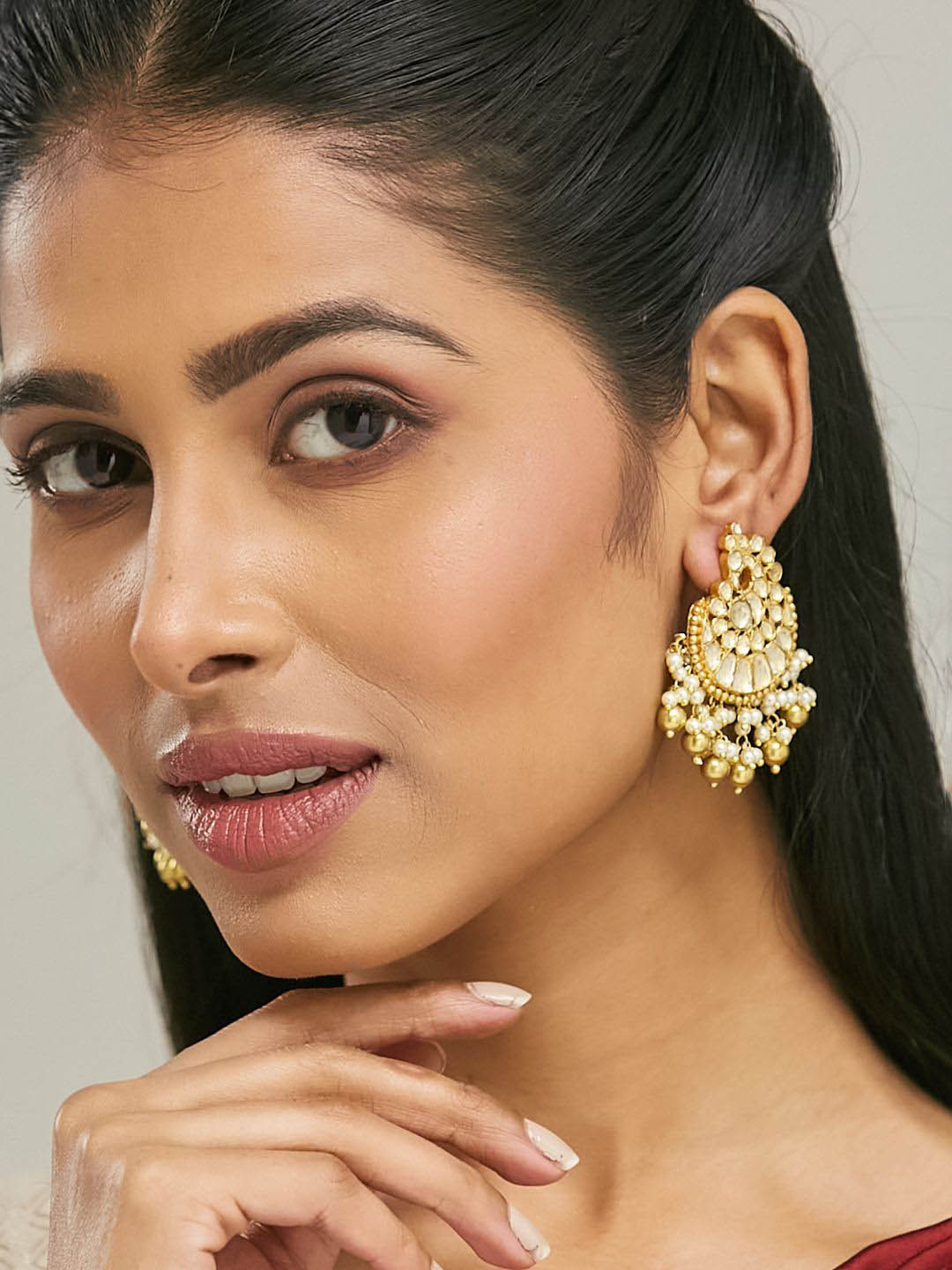 

Yinara Gold-Plated Kundan Stone Studded & Pearls Beaded Crescent Shaped Chandbalis