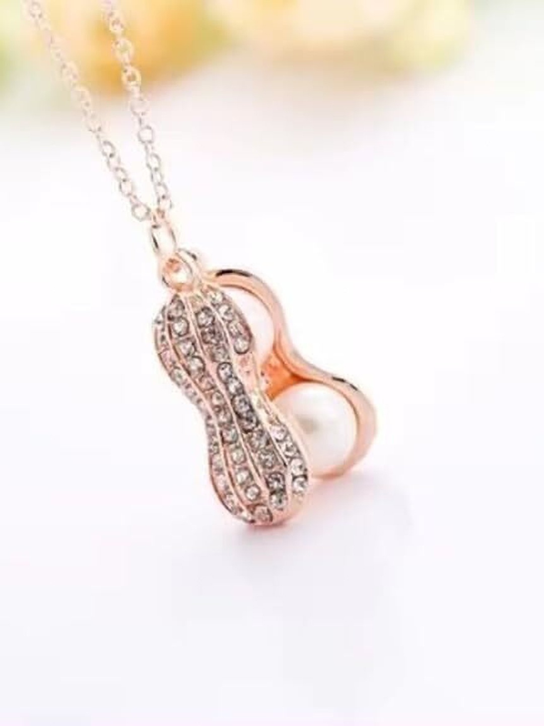 

Lila Unisex Stainless Steel Cubic Zirconia Studded Peanut Shape Pendant With Chain, Rose gold