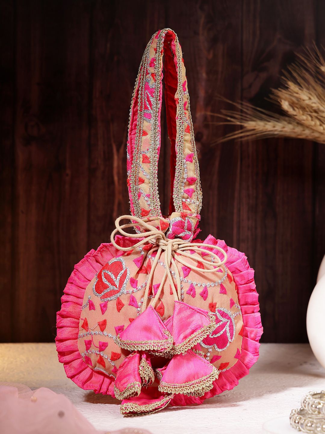 

Dhrohar Floral Embroidered Tasselled Potli Clutch, Magenta