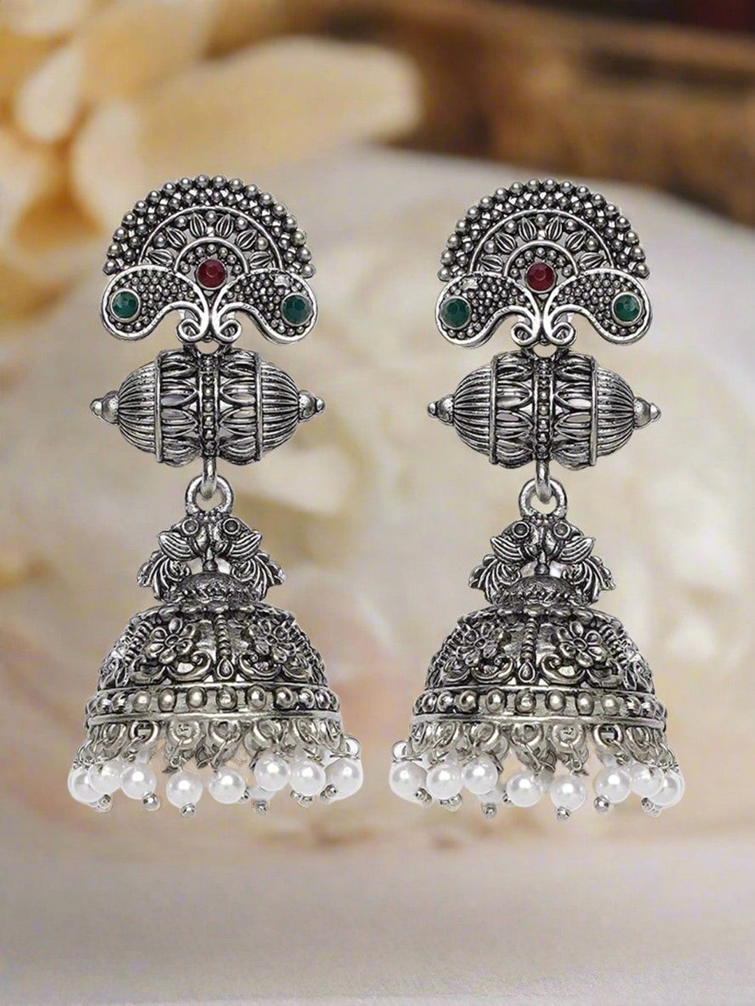

Jazz and Sizzle Silver Plated Artificial Stones and Beads Peacock Shaped Jhumkas