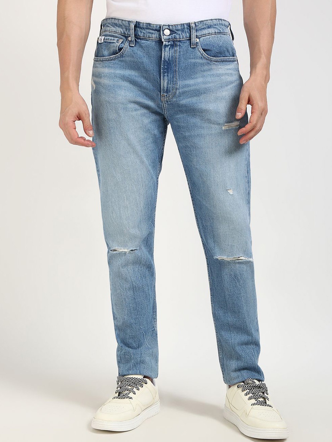 

Calvin Klein Jeans Men Tapered Fit Low Distress Heavy Fade Stretchable Jeans, Blue