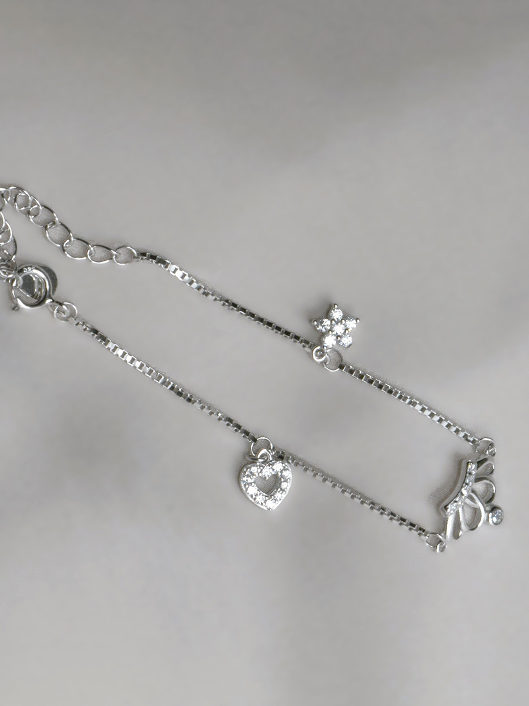 

Luxevogue Women Sterling Silver Cubic Zirconia Rhodium-Plated Charm Bracelet