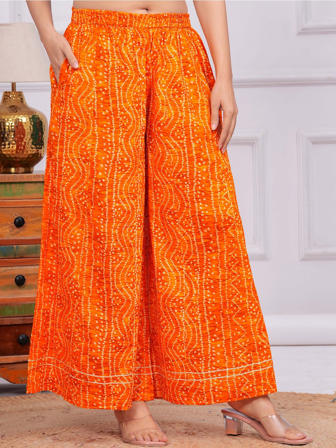 

Meeranshi Women Ethnic Motifs Printed Flared Palazzo, Orange