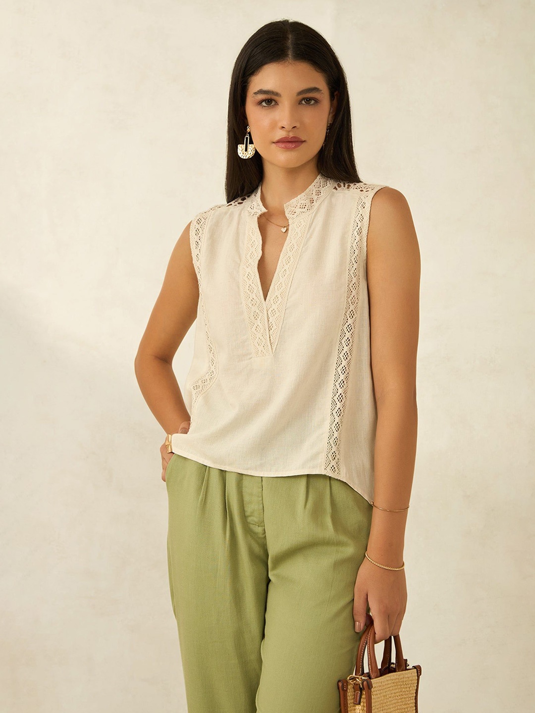 

Virgio Women Viscose Mandarin Collar Crop Length Solid Sleeveless Top, Beige