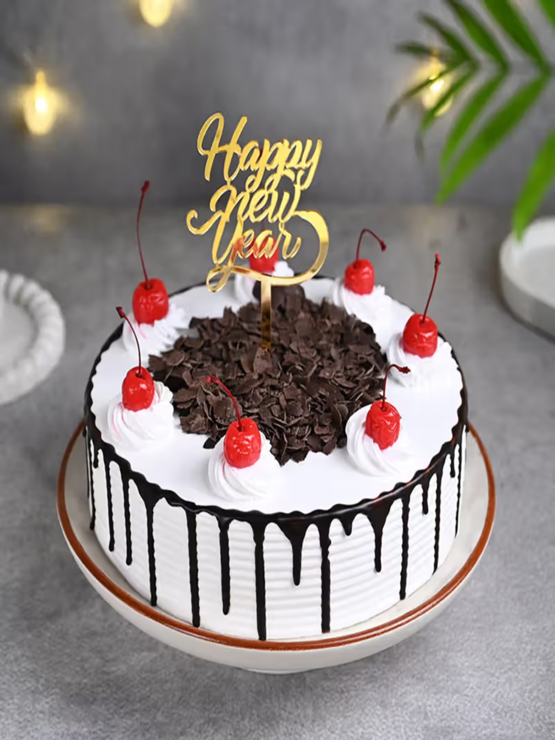 

Floweraura New Year Black Forest Flavour Eggless Round Cake With Topper 1Kg, White