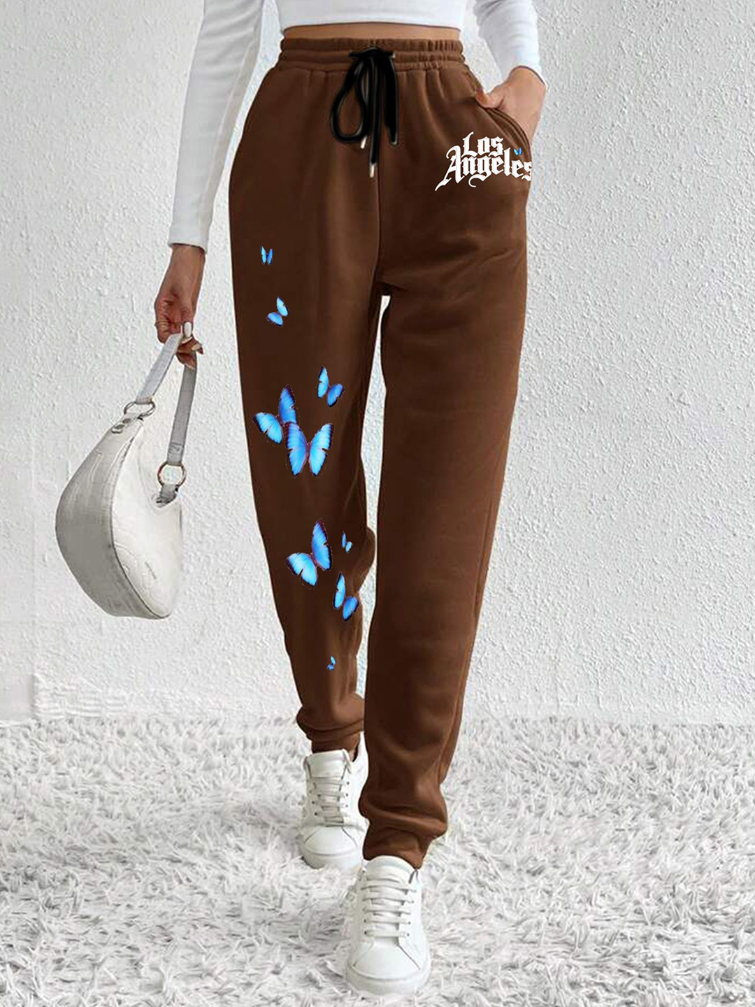 

SAAHASAM Women Printed Relaxed Joggers Trousers, Brown