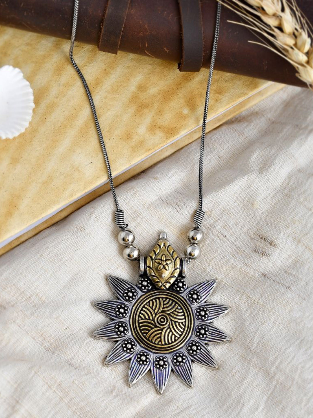 

NAMAN ARTS Gold-Plated Circular Oxidised Dual Tone Chain Pendant With Chain