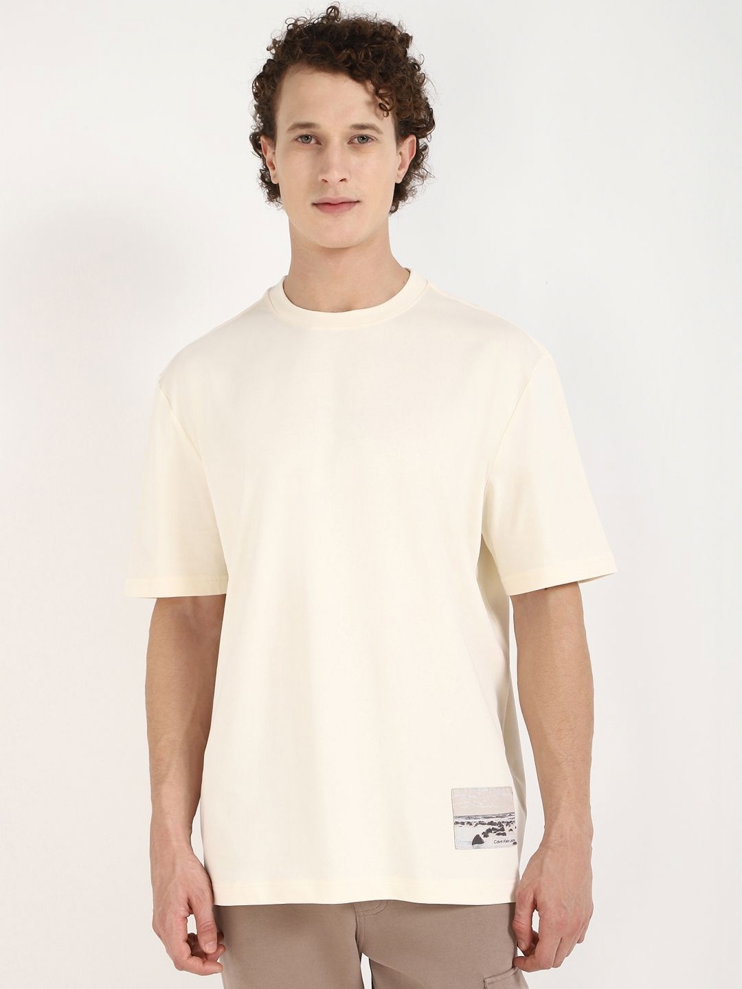 

Calvin Klein Jeans Men Graphic Printed Round Neck Cotton Oversized T-shirt, Beige