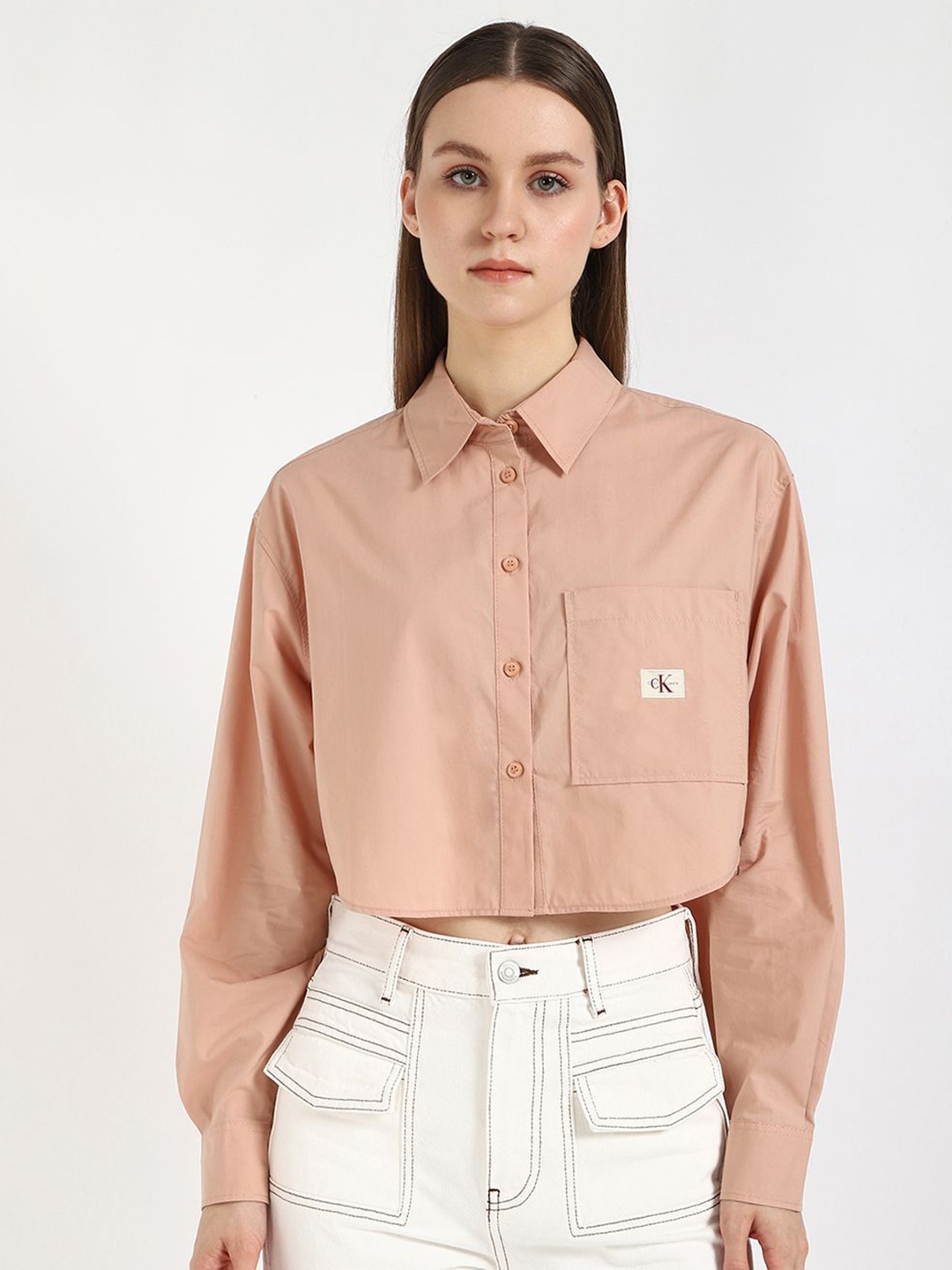

Calvin Klein Jeans Women Spread Collar Solid Cotton Casual Shirt, Peach