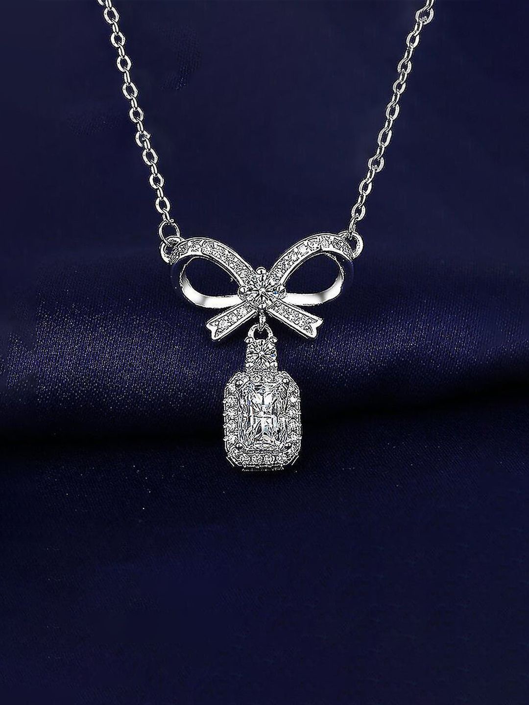 

Jewels Galaxy Silver Plated AD & Cubic Zirconia Studded Bow Pendant With Chain