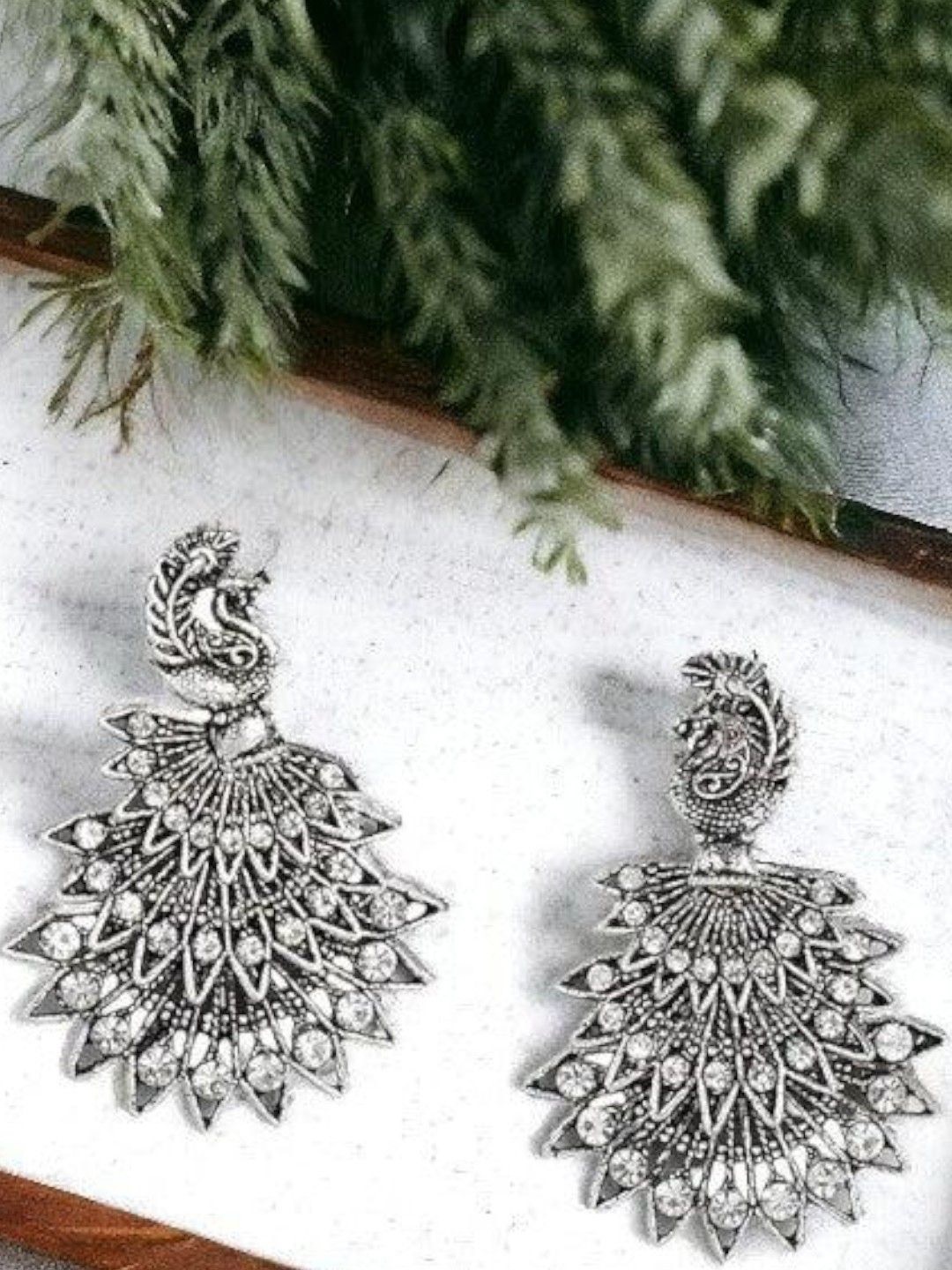 

Sangria German Silver-Plated Rhinestone Studded Peacock Shaped Oxidized Drop Earrings