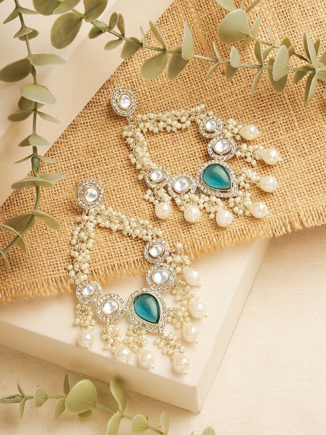 

Zaveri Pearls Gold-Plated Artificial Stones Studded & Beaded Oval Shaped Drop Earrings