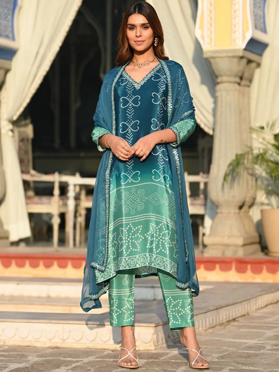 

KAYOMMI Bandhani Printed V-Neck Mirror Work Chinon Straight Kurta With Trousers & Dupatta, Blue